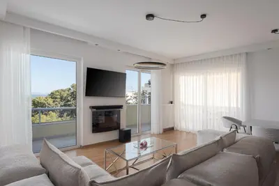 a living room with a couch and a table at Athenian Riviera Sea View Penthouse in Vari