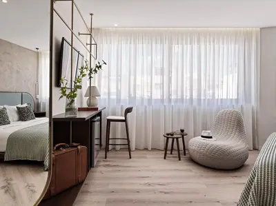 a bedroom with a bed and a desk and a chair at The Lekka Hotel & Spa in Athens