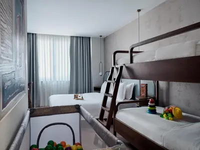 a hotel room with two bunk beds and fruit on the floor at The Lekka Hotel & Spa in Athens