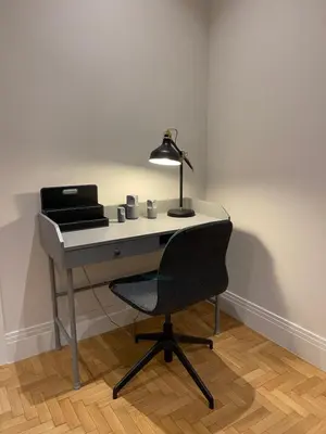 a desk with a lamp and a chair in a room at Optimal Point - Spacious Koukaki Apt in Athens
