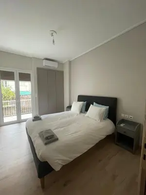 a bedroom with a large bed with white sheets at Optimal Point - Spacious Koukaki Apt in Athens