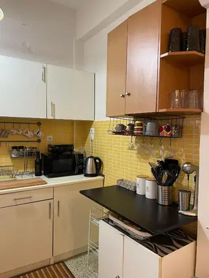 a kitchen with white cabinets and a black counter top at Home Sweet Home - 2 bedroom apartment in Athens