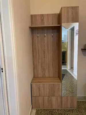 a large wooden cabinet in a room with a mirror at Home Sweet Home - 2 bedroom apartment in Athens