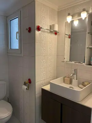 a bathroom with a sink and a toilet and a mirror at Home Sweet Home - 2 bedroom apartment in Athens