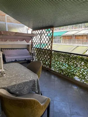a patio with a table and chairs and a tennis court at Home Sweet Home - 2 bedroom apartment in Athens