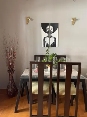 a dining room table with two chairs and a picture on the wall at Home Sweet Home - 2 bedroom apartment in Athens