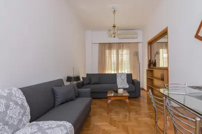 a living room with a couch and a table at Nice 2bedroom apartment in Pagkrati in Athens