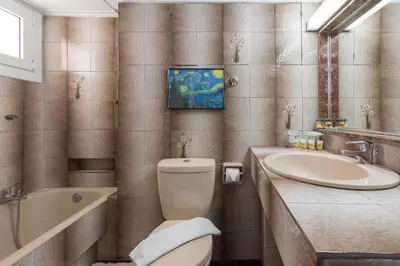 a bathroom with a toilet and a sink and a tub at Nice 2bedroom apartment in Pagkrati in Athens