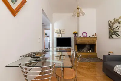 a dining room with a glass table and chairs at Nice 2bedroom apartment in Pagkrati in Athens