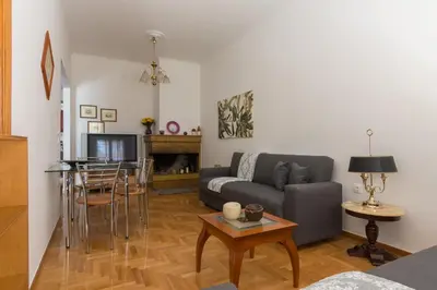 a living room with a couch and a table at Nice 2bedroom apartment in Pagkrati in Athens