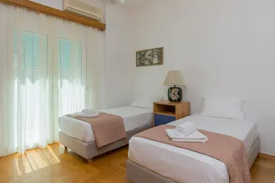 a bedroom with two beds and a window at Nice 2bedroom apartment in Pagkrati in Athens