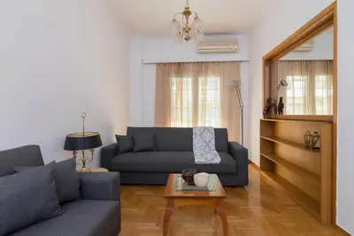 a living room with a couch and a table at Nice 2bedroom apartment in Pagkrati in Athens