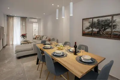 a dining room with a wooden table and chairs at niovi cozy home in Athens