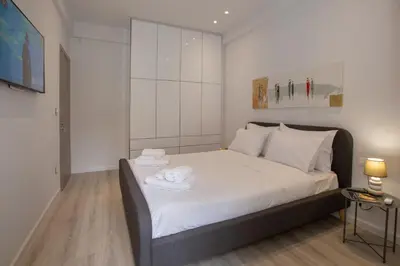 a bedroom with a bed with two towels on it at niovi cozy home in Athens