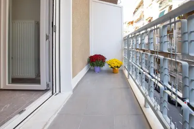 a corridor with two flowers in vases on a building at niovi cozy home in Athens