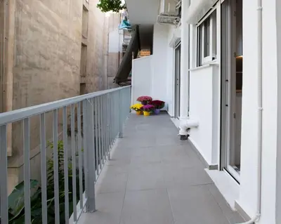 a hallway of a building with flowers on the side at niovi cozy home in Athens