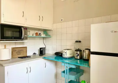 a kitchen with white cabinets and a blue counter top at Sunny Apartment (90m2) in Athens center in Athens