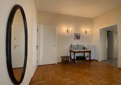 a living room with a mirror and a table at Sunny Apartment (90m2) in Athens center in Athens