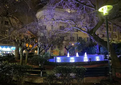 a fountain with blue lights in front of a building at Sunny Apartment (90m2) in Athens center in Athens