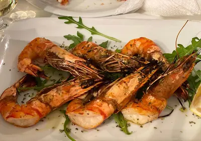 a plate of food with shrimp and vegetables on a table at Sunny Apartment (90m2) in Athens center in Athens