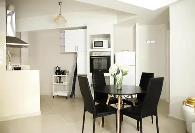 a kitchen with a dining room table and chairs at Praxitelis Luxury Apartments in Athens