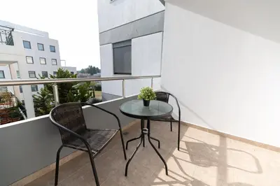 a small table and two chairs on a balcony at Stylish spacious apartment in Palaio Faliro (C1) in Athens