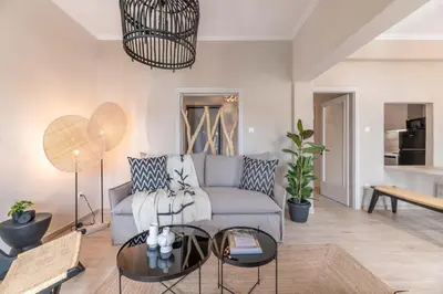 a living room with a couch and a table at Minimal Retreat w/ Watercoloured Sunset View in Piraeus
