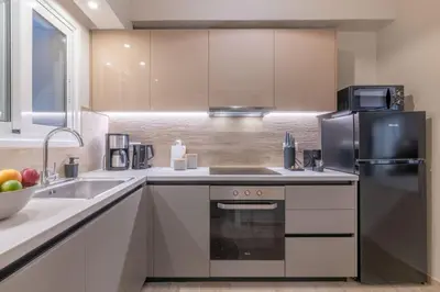 a kitchen with a sink and a refrigerator at Minimal Retreat w/ Watercoloured Sunset View in Piraeus
