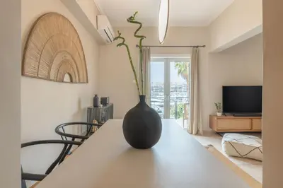 a black vase sitting on a table in a living room at Minimal Retreat w/ Watercoloured Sunset View in Piraeus