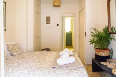 a bedroom with a bed with towels on it at Mosaics central studio apartm with Acropolis view in Athens