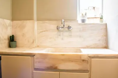 a sink in a kitchen with a counter top at Mosaics central studio apartm with Acropolis view in Athens