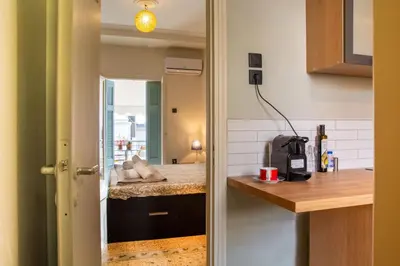 a kitchen with white walls and a counter top and a kitchen with a counter top at Mosaics central studio apartm with Acropolis view in Athens
