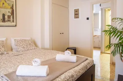 a bedroom with a bed with two towels on it at Mosaics central studio apartm with Acropolis view in Athens
