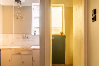 a bathroom with a sink and a window at Mosaics central studio apartm with Acropolis view in Athens