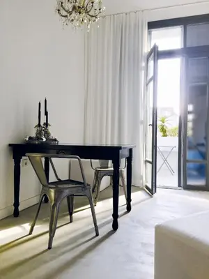 a dining room with a table and a chair at Susanna Apartments - Your Oasis in Athens Ano Petralona in Athens
