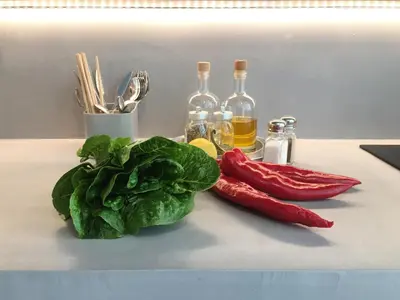 a counter with some vegetables and bottles of wine at Susanna Apartments - Your Oasis in Athens Ano Petralona in Athens