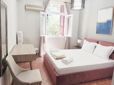 a bedroom with a bed and a desk and a chair at Under the Rock of Acropolis by YHA in Athens