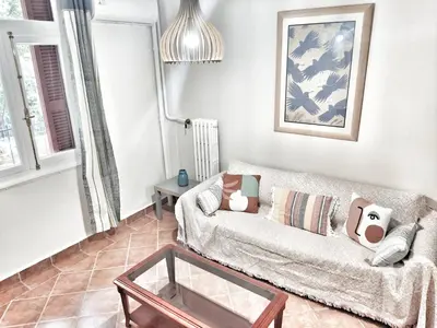 a living room with a couch and a glass table at Under the Rock of Acropolis by YHA in Athens