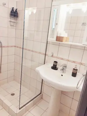 a bathroom with a sink and a shower at Under the Rock of Acropolis by YHA in Athens