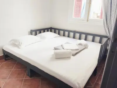 a bed with towels on top of it at Under the Rock of Acropolis by YHA in Athens