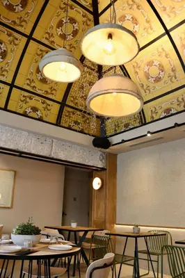 a dining room with tables and chairs and a ceiling at PAREA Athens in Athens