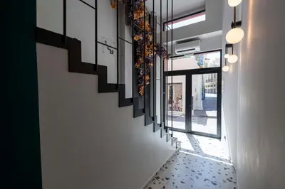a hallway with stairs in a building with windows at PAREA Athens in Athens