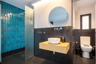 a bathroom with a sink and a toilet and a mirror at PAREA Athens in Athens