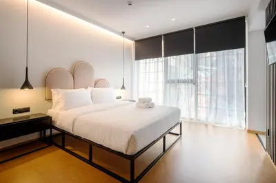 a bedroom with a large bed and a large window at PAREA Athens in Athens