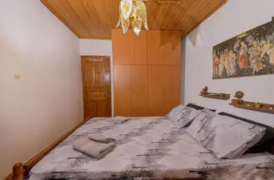 a bedroom with a bed with a painting on the wall at Marin Holiday in Dhaskalión