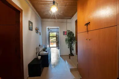 a hallway of a house with a door and a table at Marin Holiday in Dhaskalión