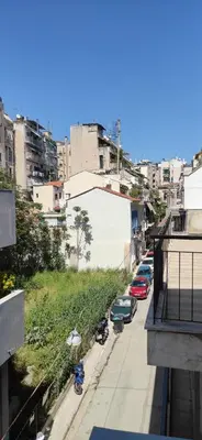 a street with cars parked on the side of a city at JiMMYS STUDIO, KALIMARMARO in Athens
