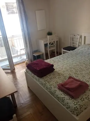 a bedroom with a bed with two towels on it at JiMMYS STUDIO, KALIMARMARO in Athens