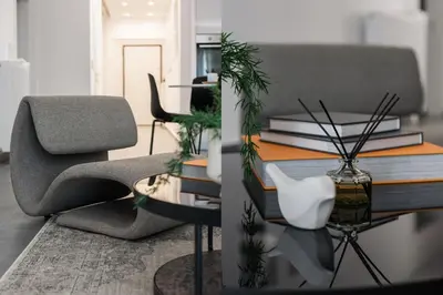 a living room with a chair and a table with books at Stellar 3BR Apartment with Balcony by UPSTREET in Athens