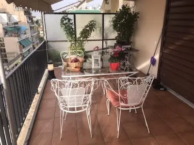 a table and chairs on a balcony with plants at Enjoy the silence and view in Athens